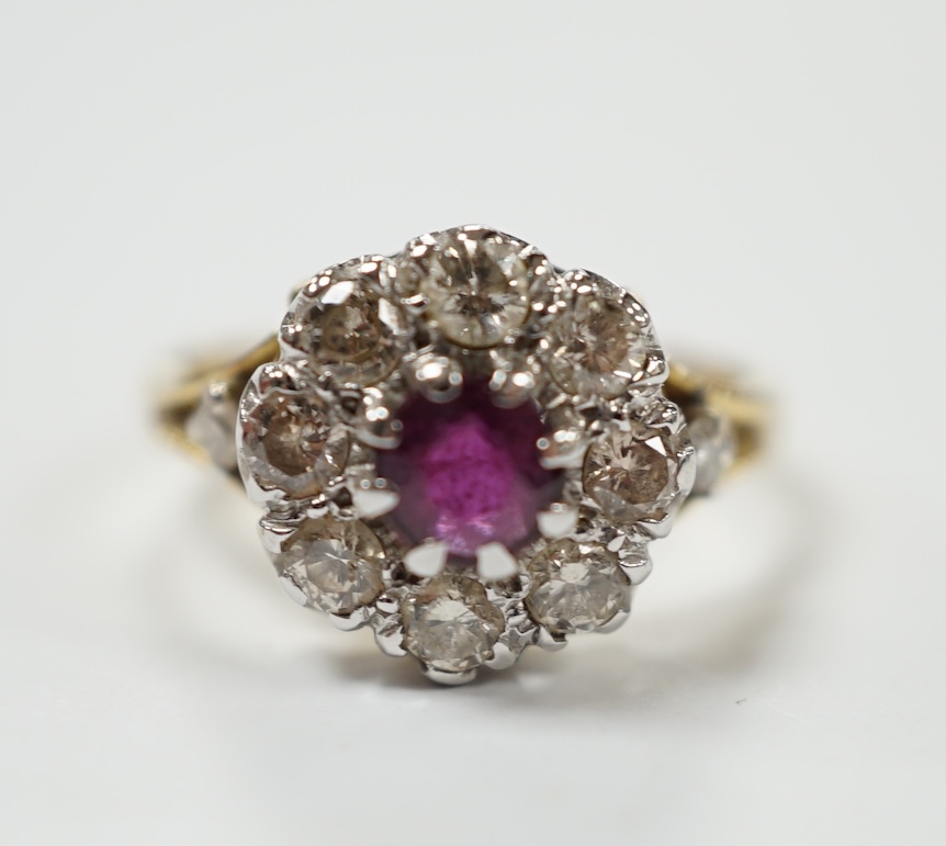 A yellow metal ruby and diamond cluster set flower head ring, size I/J, gross weight 3.6 grams. Condition - fair